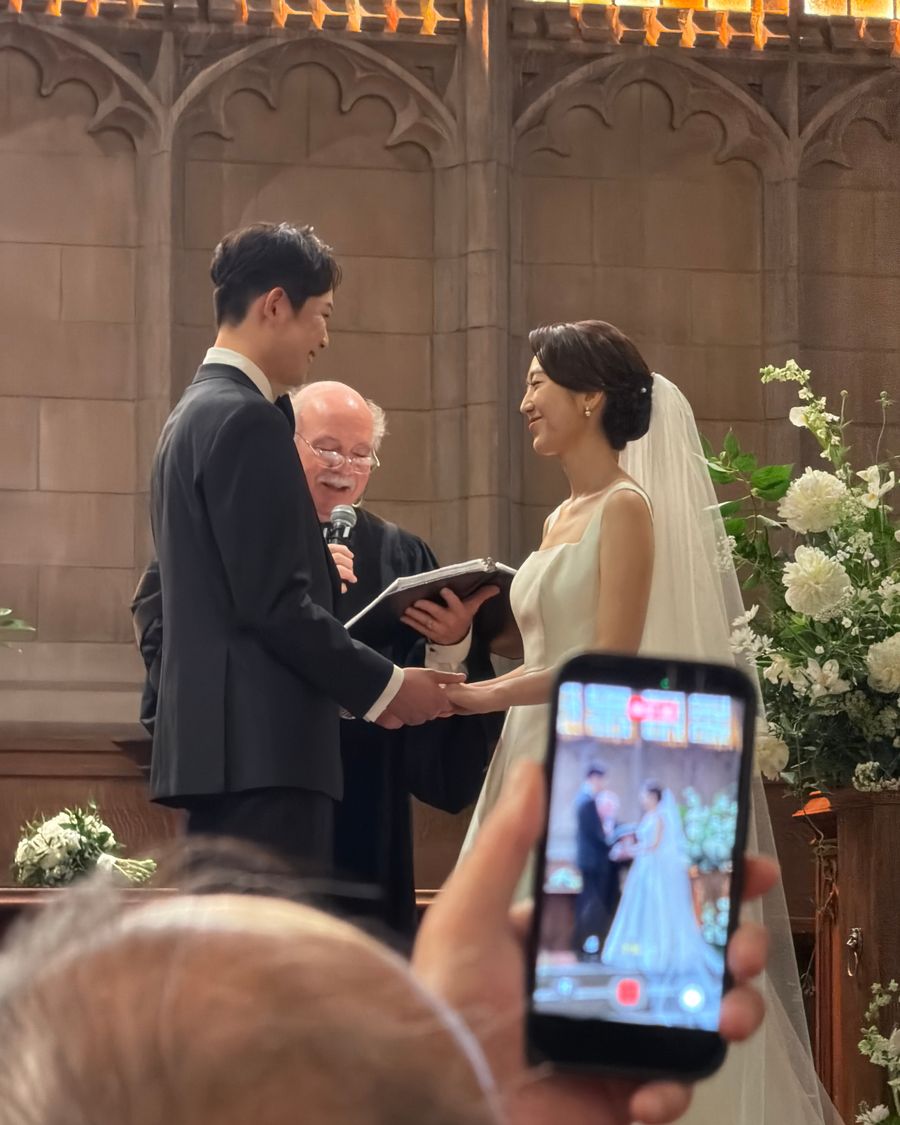 A guest filming the vows on their phone