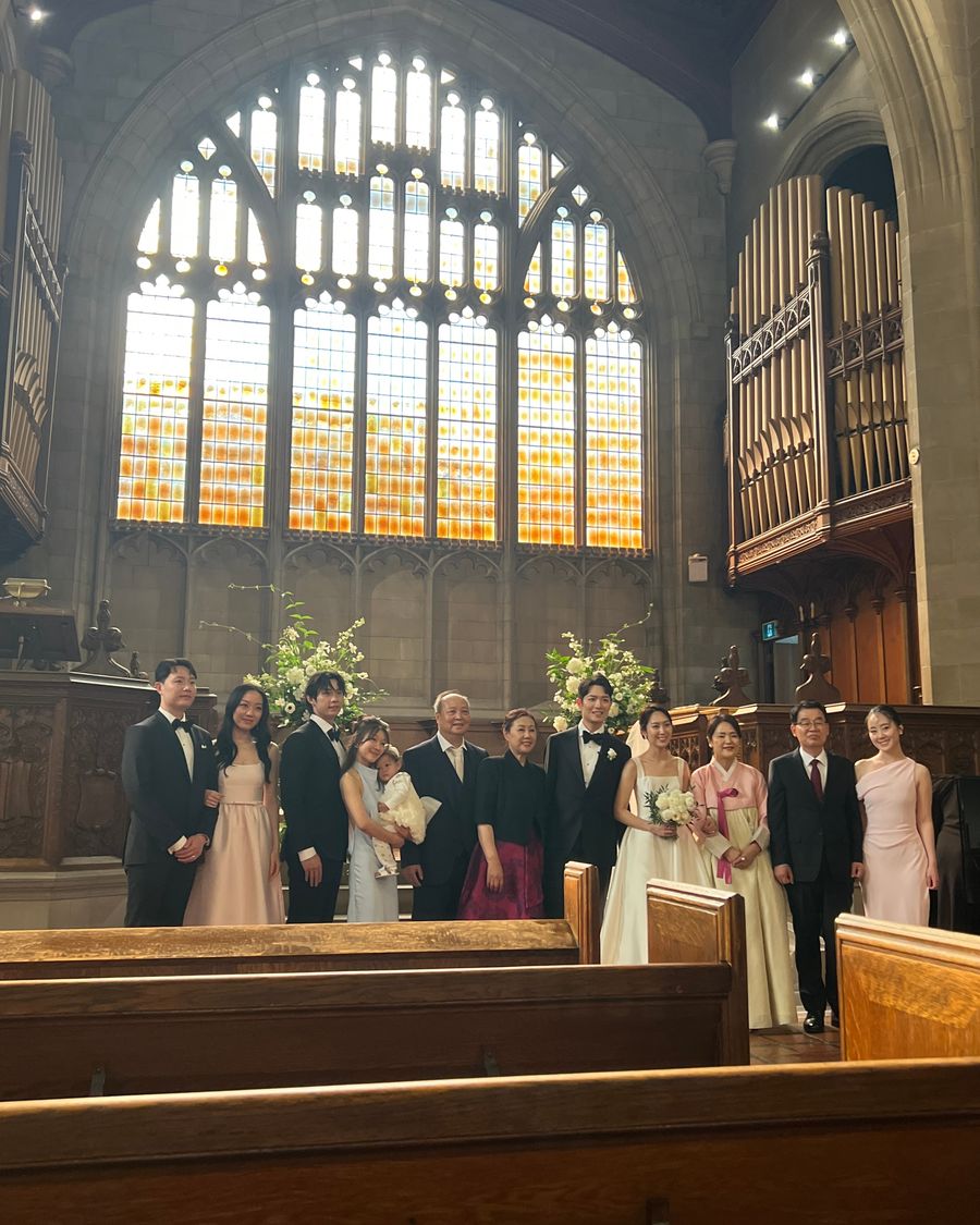 Family group photo in front of the stained-glass window